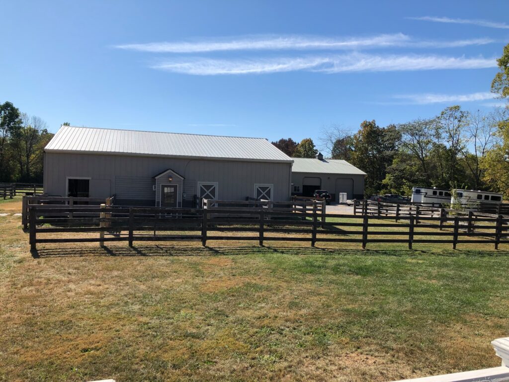 Barn and paddock at Top Hat Stables in Goshen